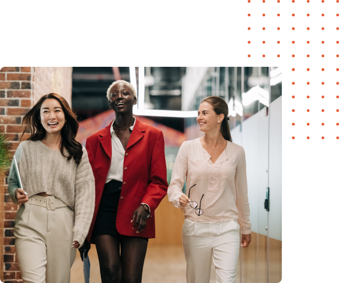 Three women from different cultures walking in an office