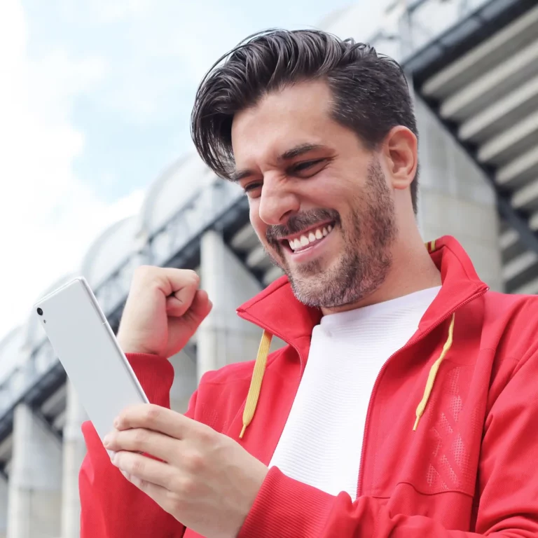 man in red jacket excited with cellphone