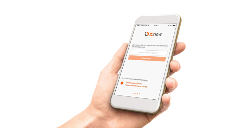 hand holding a smartphone with IDnow log in page